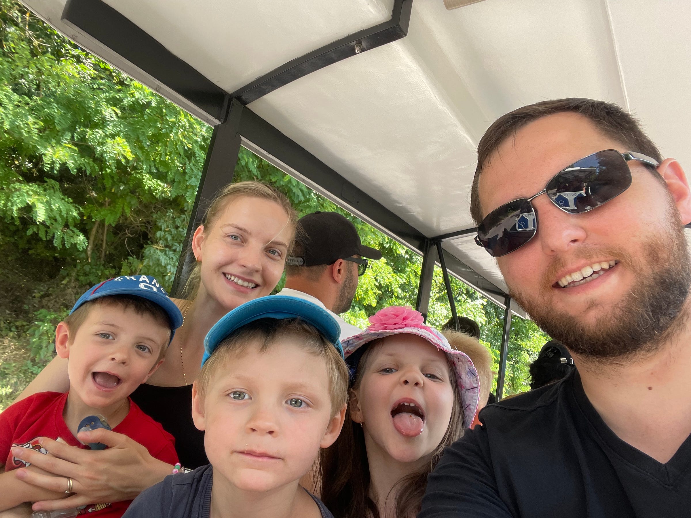 My family smiling on a mini-train on our holidays