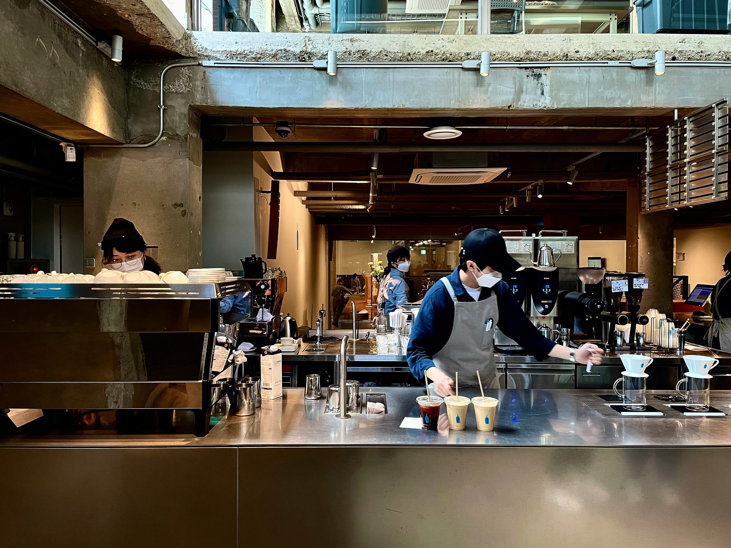staff serving coffees in a cafe