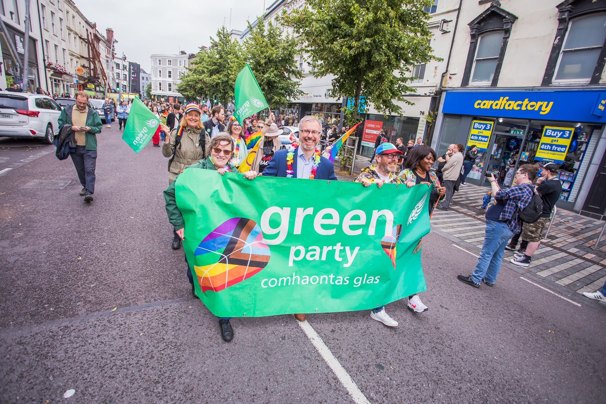 Green Party members marching behind a banner with Green Party leader and Minister for Children, Equality, Disability, Integration and Youth, Roderic O’Gorman, at the Cork Pride parade.