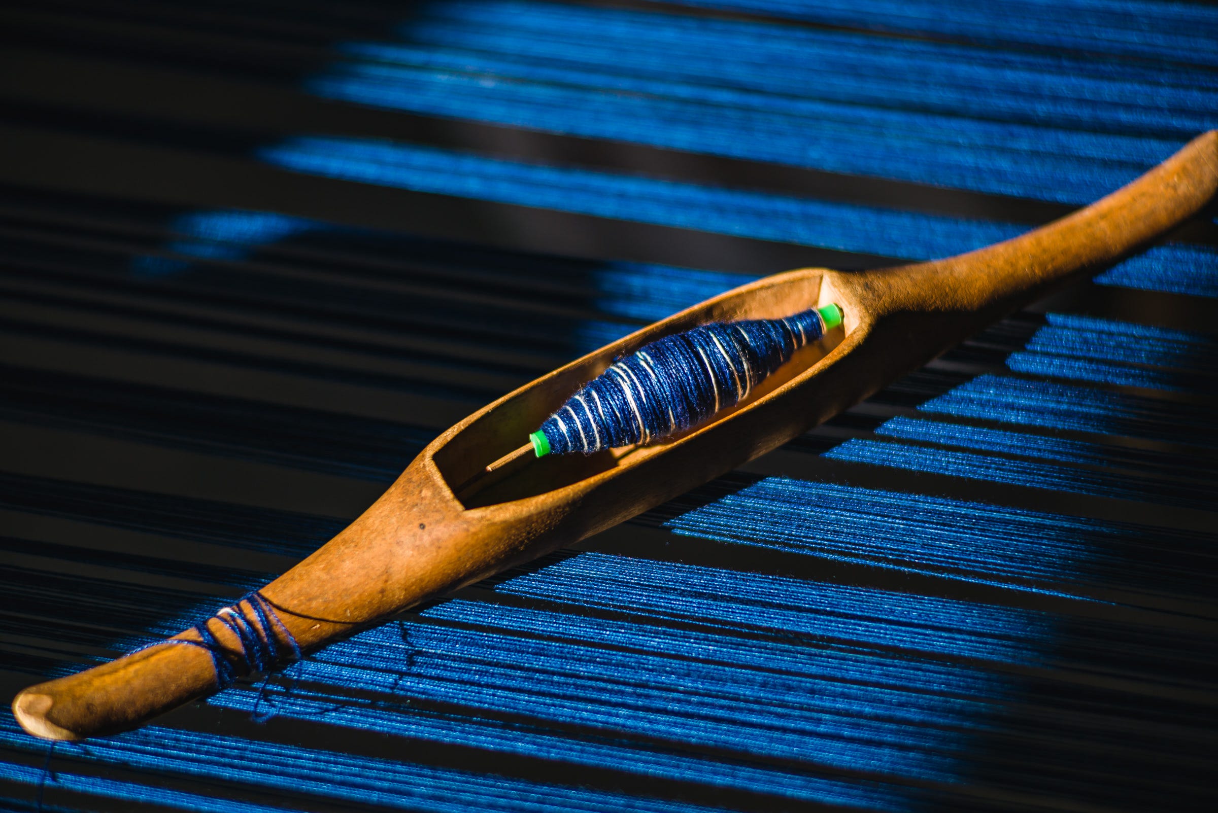 Close-up of a shuttle on a traditional weaving loom