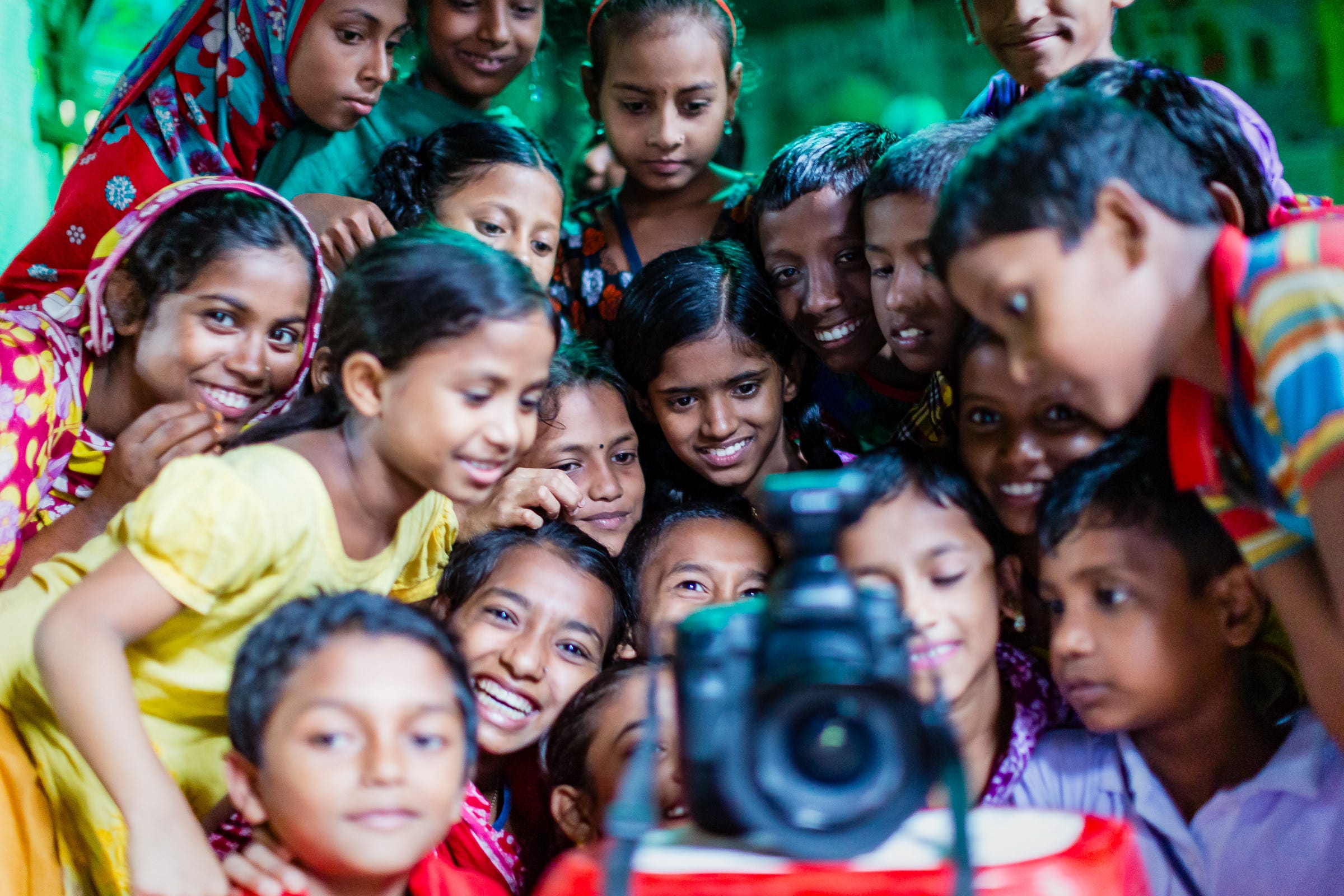 Children reviewing the photographs of themselves in their classroom, Dhaka, Bangladesh