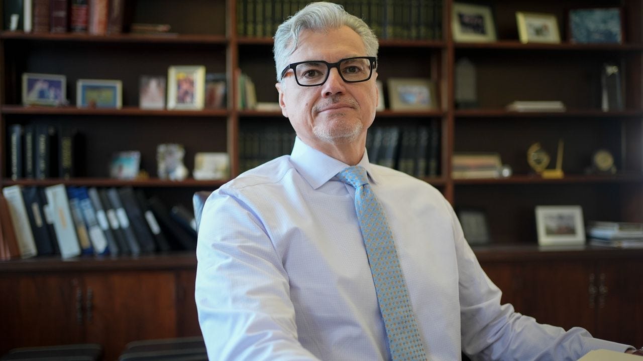 Judge Juan Merchan poses for a picture in his chambers in New York on Thursday, March 14, 2024.
