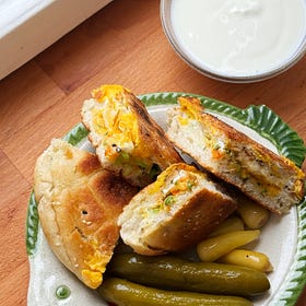 crispy harissa and egg stuffed sandwiches with garlicky yogurt and pickles