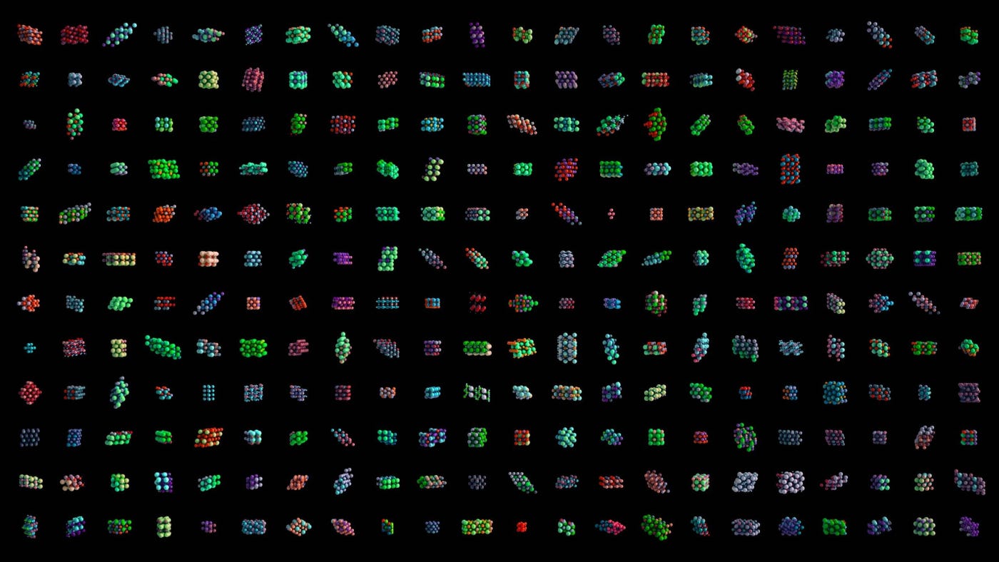 A grid of colorful, abstract shapes on a black background. Each cell in the grid features a unique three-dimensional geometric pattern, showcasing a variety of colors including green, red, blue, and purple.