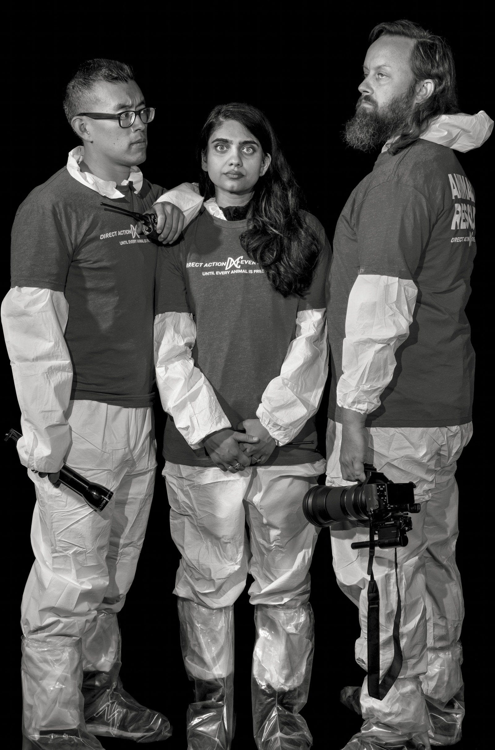 DxE members Wayne Hsiung Priya Sawhney and Paul Darwin Picklesimer wearing Tyvek suits