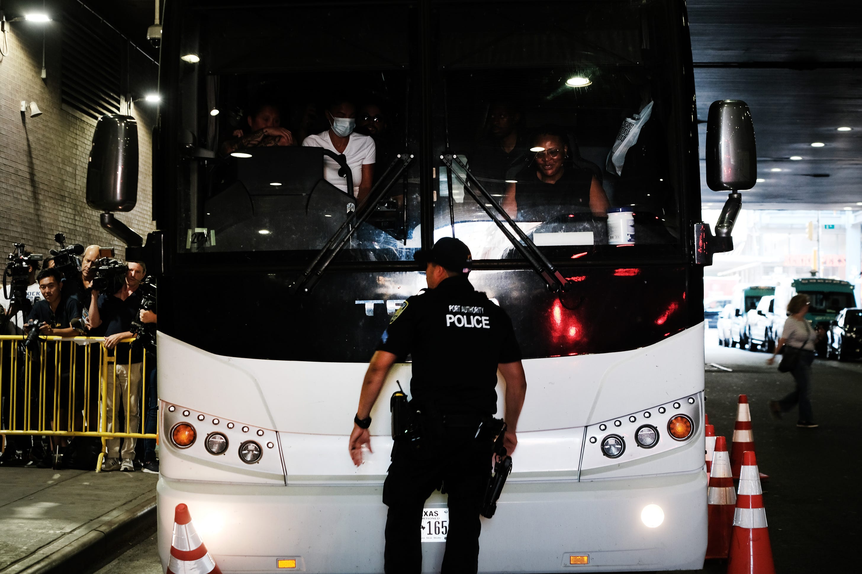 A bus carrying migrants who crossed the border from Mexico into Texas arrives in New York City. (Photo by Spencer Platt/Getty Images)