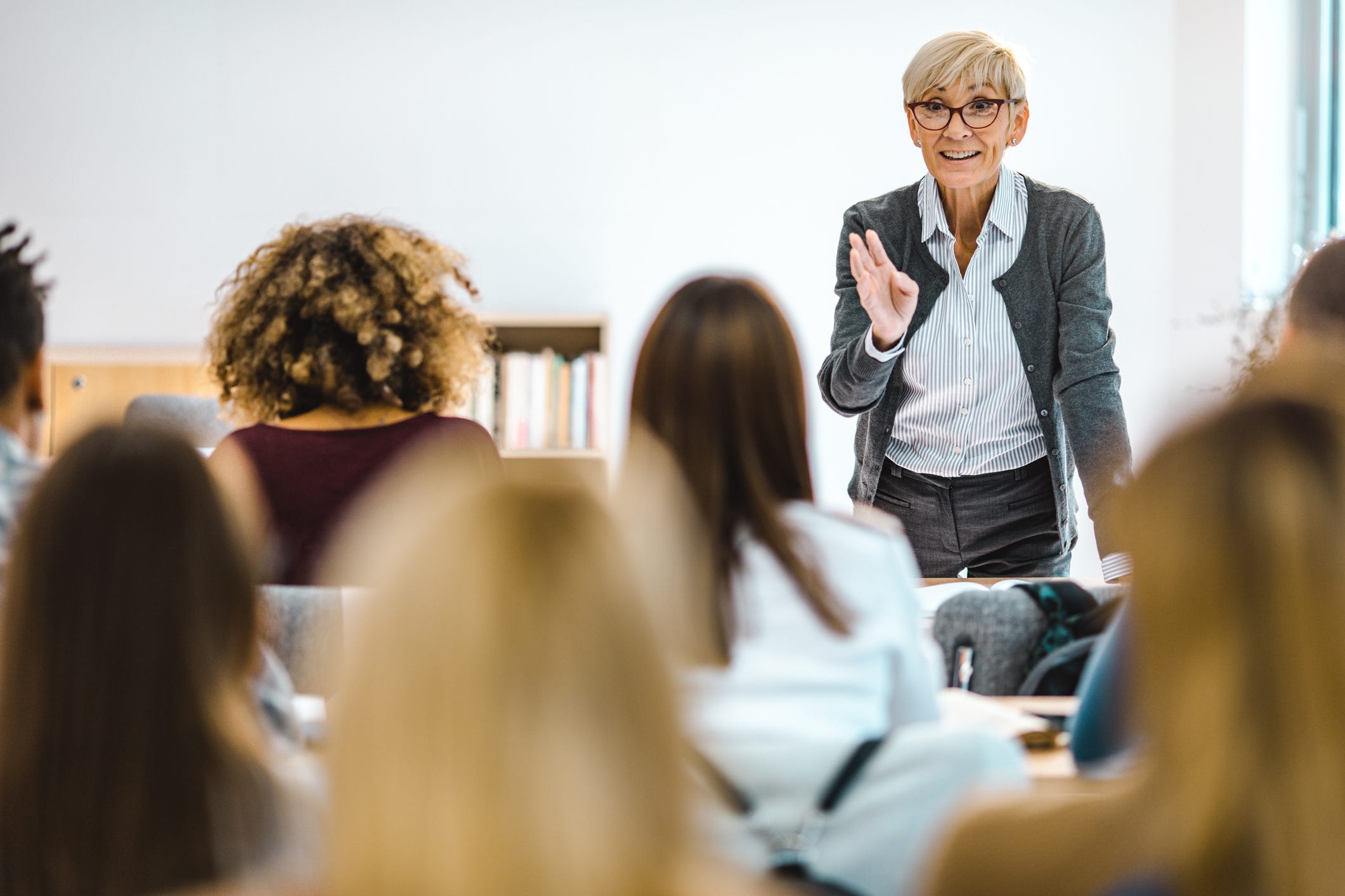 A professor leads a classroom discussion with students.