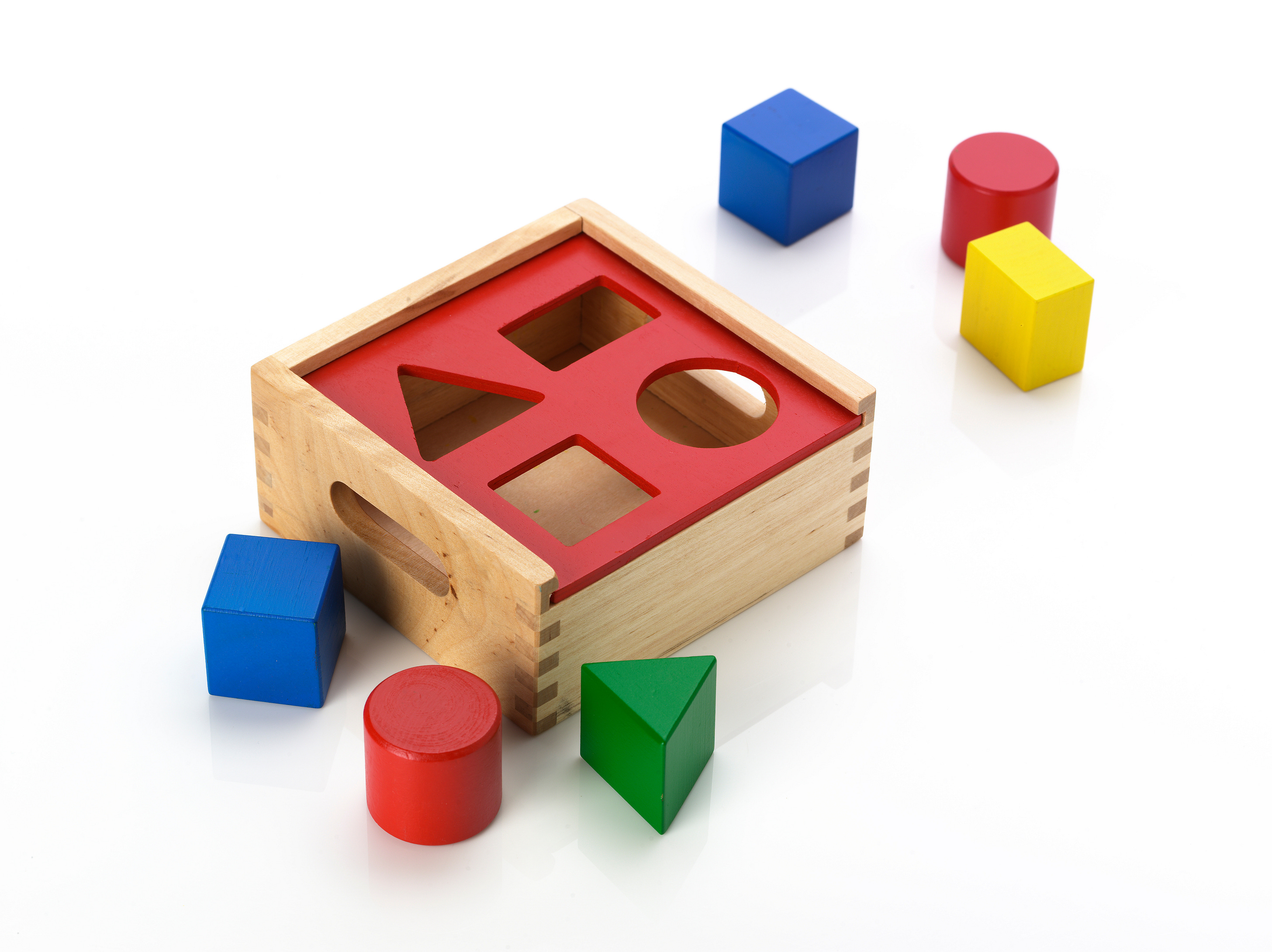 one of those baby toys with blocks of different shapes and a template of those shapes to put them through