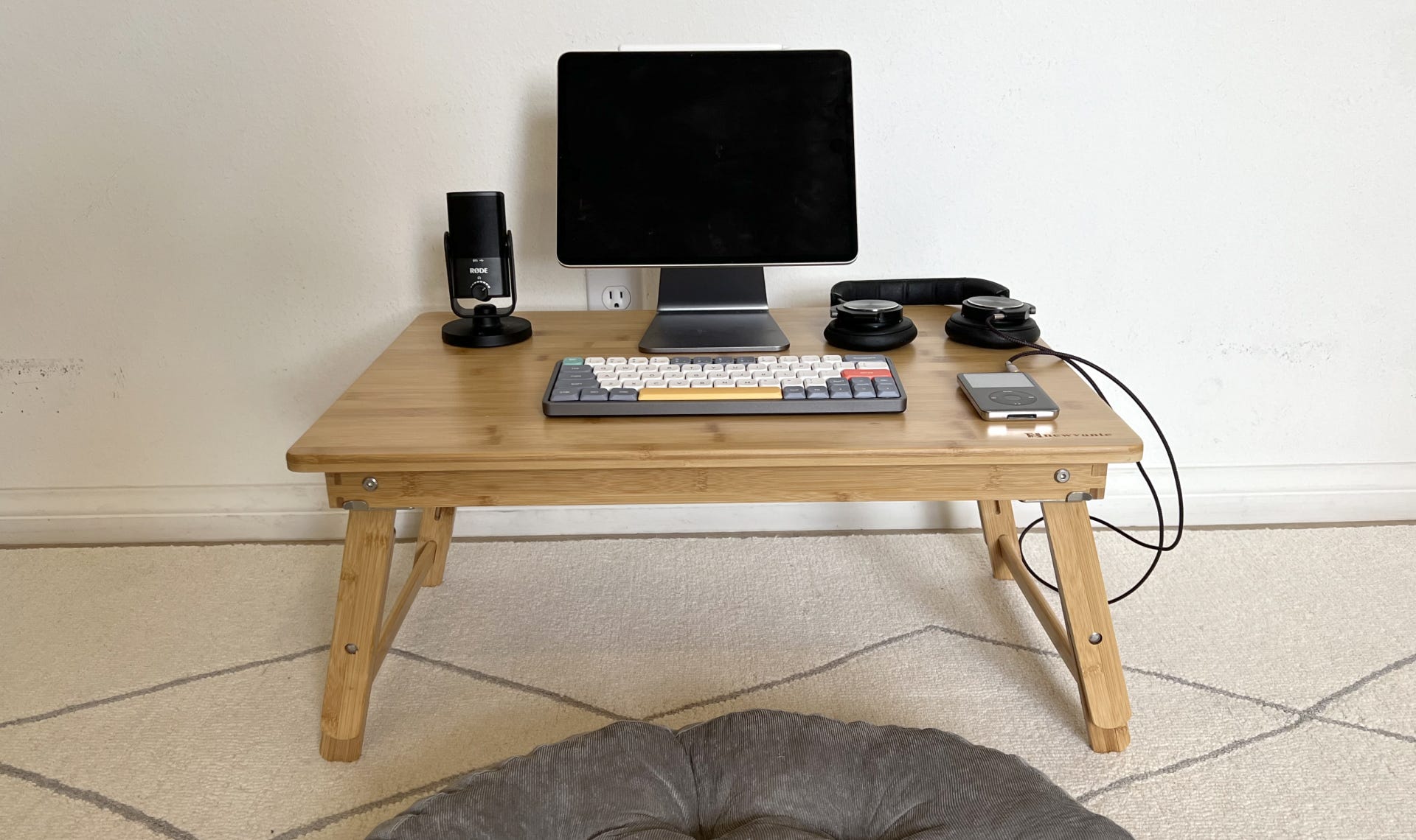 Bamboo desk with devices on top of it