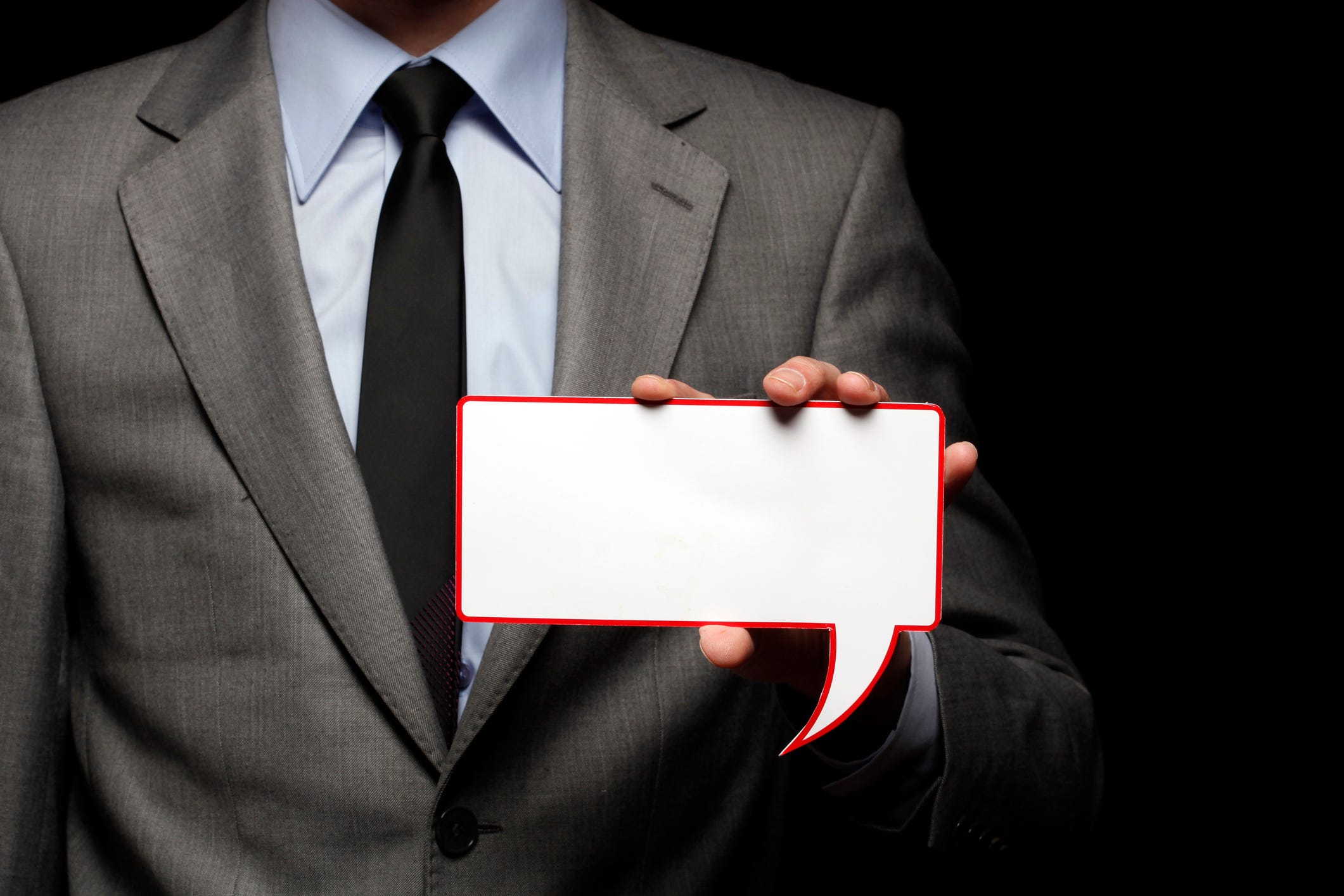 A college administrator holds a speech bubble.