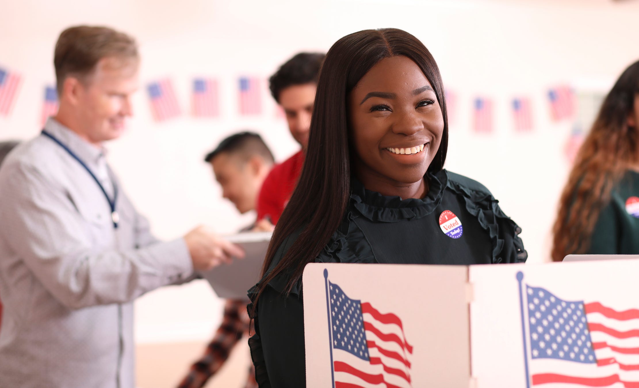 A happy woman votes.