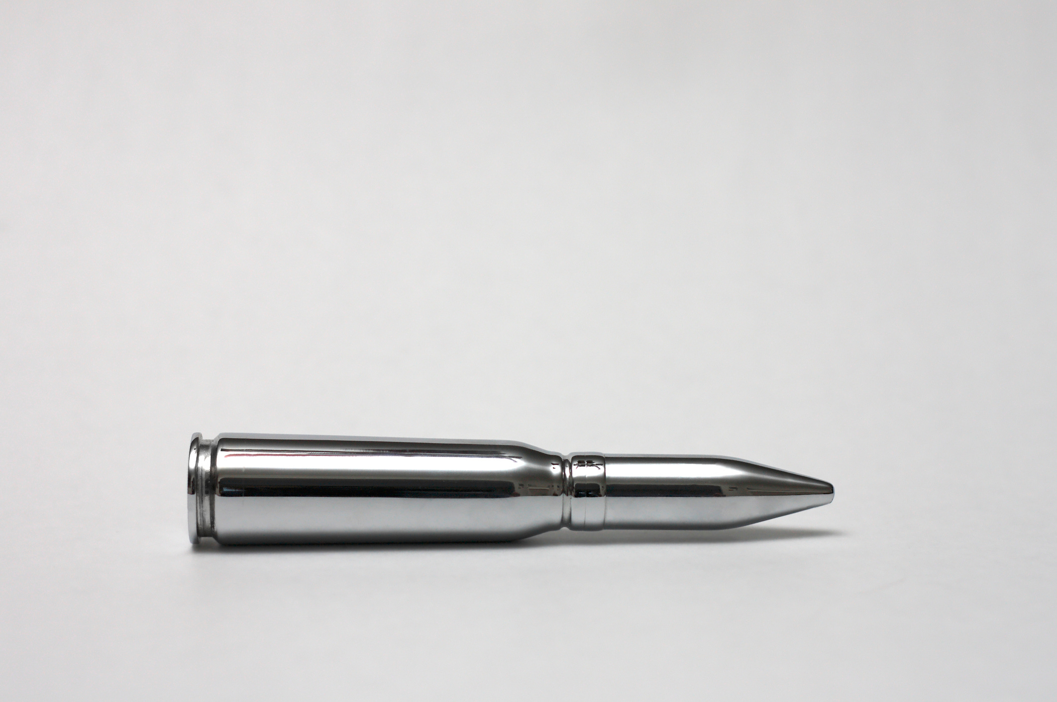 A silver bullet on a white background.