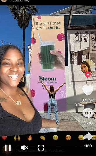 Photo of a TikTok where the creator of an original sound calls out a brand for making a billboard that says "The girls that get it, get it."