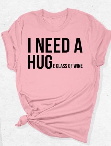 May include: A pink t-shirt with the text 'I need a hug and a glass of wine' in black text. May include: A pink t-shirt with the text 'I need a hug and a glass of wine' in black text.