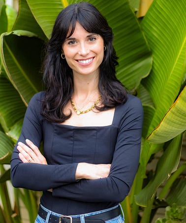 Ashley Frohnert, Director of Social Media at PETA, standing in front of trees