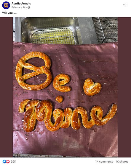 example facebook post from auntie anne's that says "will you..." and then shows a photo of pretzels spelling out "be mine"