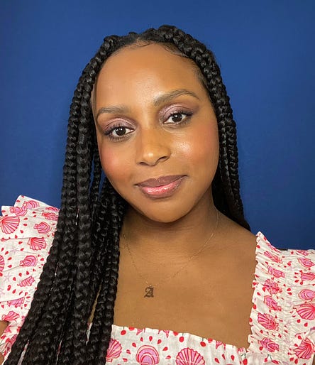 Photo of Alexis Wilson, social media editor at Entertainment Weekly, against a blue backdrop