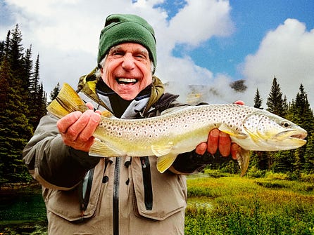 Image may contain Henry Winkler Face Head Person Photography Portrait Animal Fish Sea Life Trout Clothing and Hat