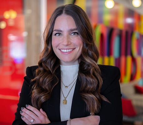 Photo of Bari Rosenstein, social lead for Auntie Anne’s and Jamba, wearing a blazer and standing with her arms crossed