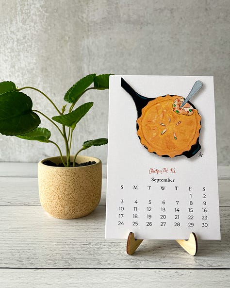 Images of the 2023 pie calendar including illustrations of chicken pot pie, strawberry rhubarb pie, and cherry pie.