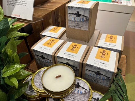 Various Mana Up brand products paying tribute to Duke Kahanomoku, from clithing to candles, chocolate, and hand lotion.