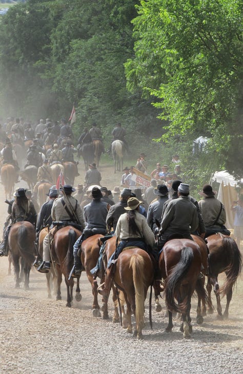 Images of Civil War soldiers and horses taking part in a battle reenactment in Gettysburg. You can read the full post on Past Lane Travels.