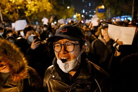 Night time protests in China against Covid restrictions, including people holding up blank paper