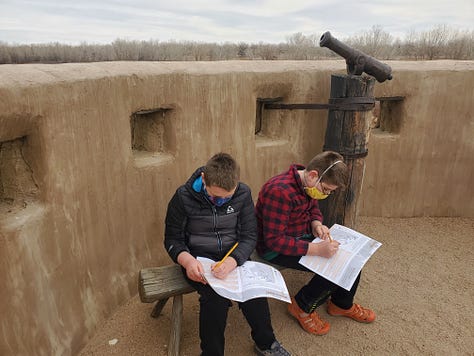 6 images of two boys homeschooling from different places, including an RV and on the beach