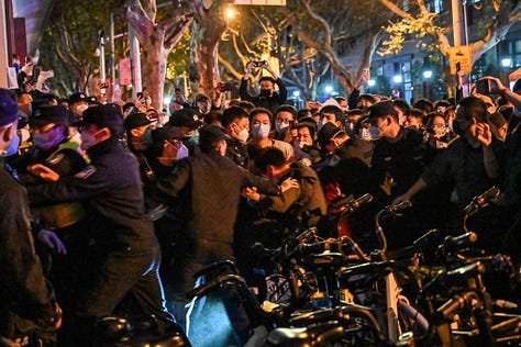 Night time protests in China against Covid restrictions, including people holding up blank paper