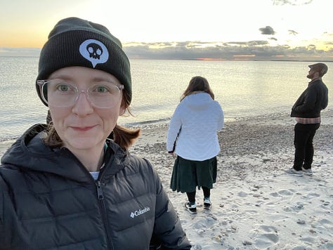 The beach at sunset, a warning sign on a rocky outcropping, me bleary-eyed and beanie-clad on my first dawn walk, the stunning 'eye of god' sunrise on my second dawn walk, and four of my classmates posed on a rocky outcropping