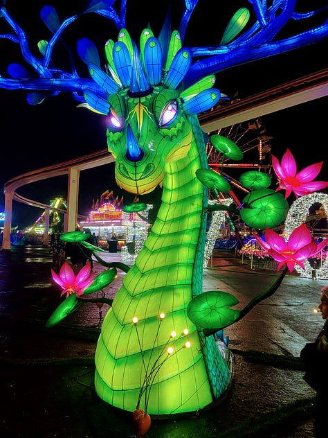 Left: Lighted dragon. Middle: two people in front of blue lighted tree. Right: Girl sticking head in lighted teddy bear cut-out.