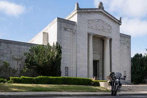 Photo 1: Tom pedals his bicycle up a steep hill in Mountain View Cemetery. Photo 2: A wide-angle photo of Mountain View Cemetery with headstones in the foreground, a handful of trees in the middle ground, and more trees and headstones in the distant background. Photo 3: The imposing white marble facade of a mausoleum at the Mountain View Cemetery.