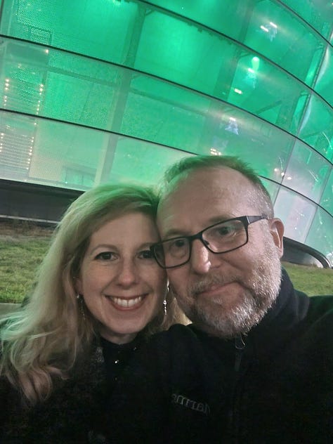 Heather and Dave at The Cure concert with images of the band
