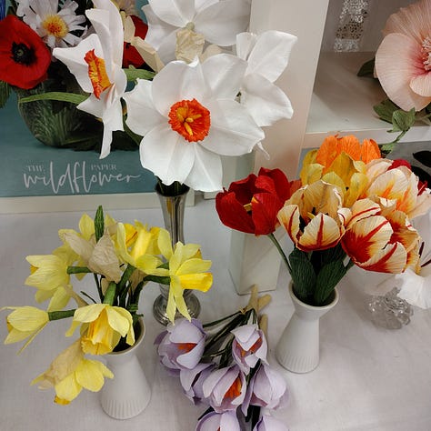 A colourful selection of gladioli, crocus, narcissus, daffodils, tulips, Icelandic poppies and morning glories, all made out of vibrant shades of crepe paper