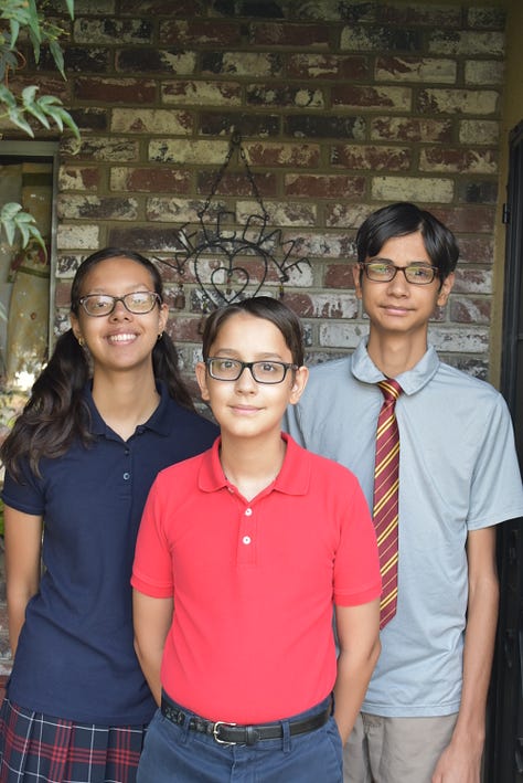 children in school uniform on front porch