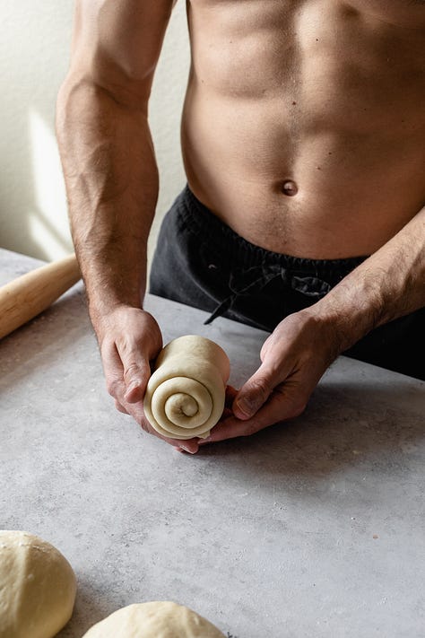 Shirtless baker in black pants making vegan milk bread loaves