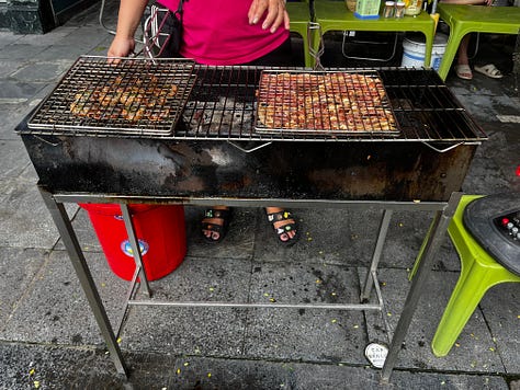 the Religion Publishing House, a pho stand, people cooking meat on the street for banh mi and bun cha, and Craft Link, a social enterprise shop encouraging economic development and helping rural women support themselves by "seeking new markets for traditional artisans."    