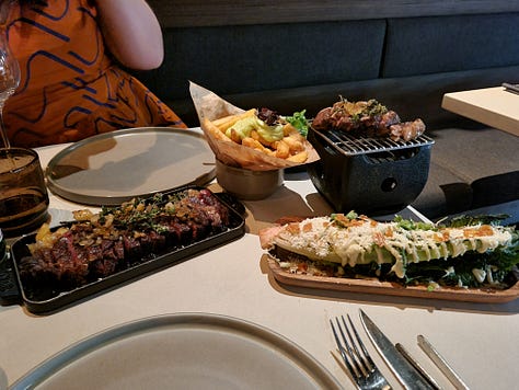 Photo 1: view from our table at Maven showing the sides of beef hanging to dry age and the meat select counter at ground level. Photo 2: photo of Dave in the kitchen talking to 3 Maven chefs. Photo 3: photo of main course including Angus steak, Wagyu steak, frites, and caesar salad.