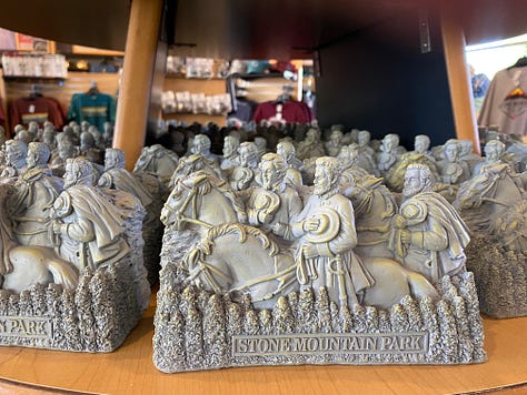 Images of confederate soldiers carved into the side of a mountain, then several photos of objects from the gift shop that have the same image; and the last photo is of a racially mixed group of school children on a field trip