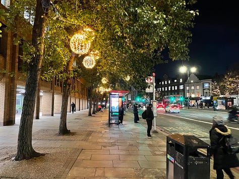 A variety of pictures of London streets at night. One shows a bus stop with people waiting at it. Another a bike locker and other bike parking. Another shows a van and car for hire. The rest show street scenes with Georgian town houses and empty streets lit by street lights