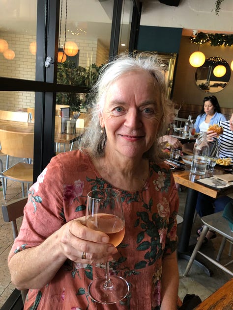 An image of a woman drinking a glass of wine, a coffee with the word queen on it and two lunches