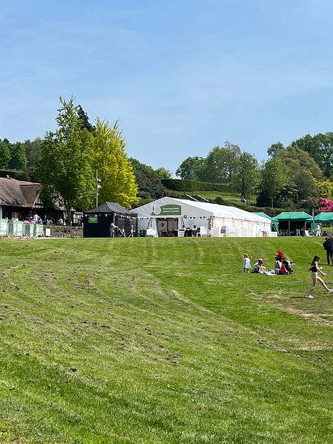 White tent in a town park, portrait of chef Will Devlin, restauranteur Atul Kochhar with Rosemary Shrager 