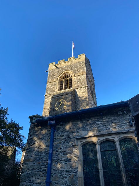 Left: a grey stone church building against a blue sky. Center: a church interior featuring columns with text and decorative stenciling, a wooden roof with Scripture verses on the crossbeams, and a chancel with stained glass. Right: a column with 2 Timothy 4:2 written on it.