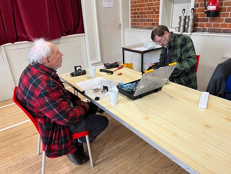 People at work fixing peoples’ broken home appliances at a weekend repair cafe