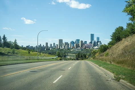 Pink greatest hits play list to get in concert mood, Coming into Edmonton with a view of the downtown, Crossing the bridge in Edmonton with views of the Fairmont Hotel in the distance, A Samsung phone shot of the Fairmont Hotel Edmonton AB.  Sunshine shines through the windows in a hallway of the Fairmont Hotel Edmonton. A side entrance of the Hotel Fairmont Macdonald, in Edmonton.  