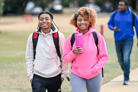 Students walk across the Troy campus heading to class