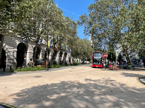 Pictures of the Strand Aldwych scheme. Many of the pictures are of pedestrian spaces, with extensive planting throughout and trees. People are walking in the street, and sitting at provided benches. There is one picture with someone on a bicycle, and another picture with my outside the disused Strand station