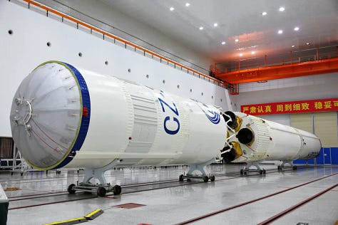 The third-stage of the rocket undergoing hardware installation, one of the boosters being lifted during stacking, and the first and second stages ahead of pre-launch operations on the launch pad.