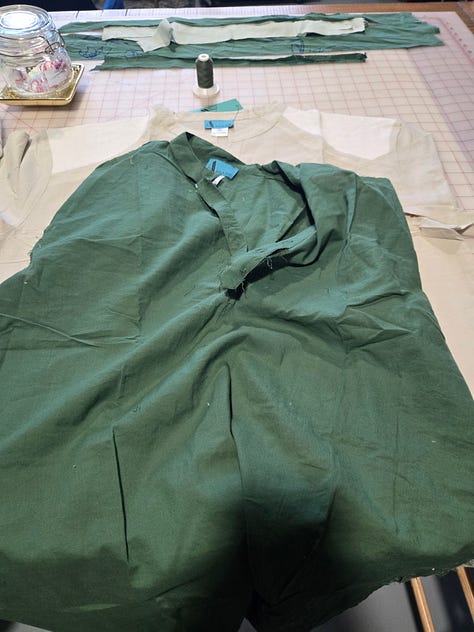 A green and tan shirt partially dissassembled.