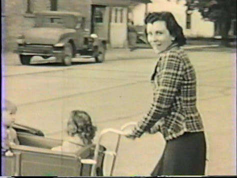 A two-year-old girl walking, parents holding a 1-year-old, and mom pushing a baby carriage in the late 1930s